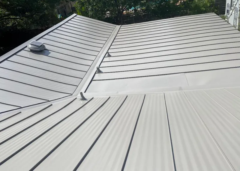 Solar attic fan installed on a metal roof for Roof Ventilation in Seven Hills